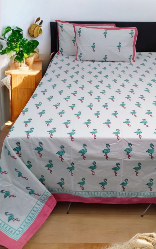 Bed with flamingo patterned bedding in a bedroom setting