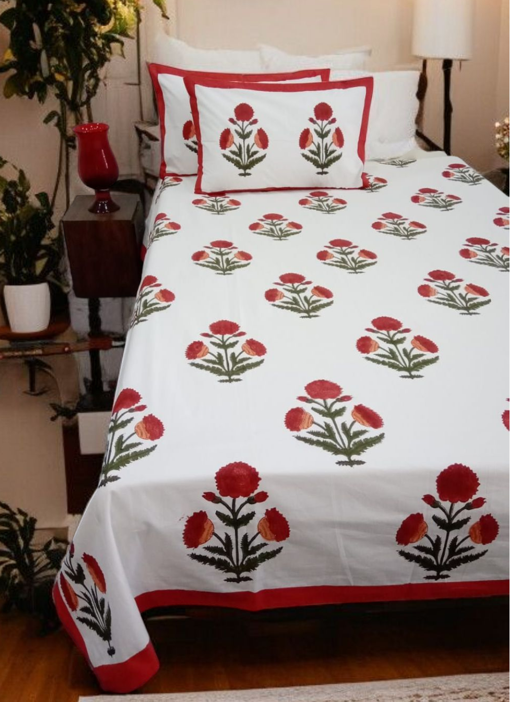 Floral patterned bedspread on a bed with matching pillows in a bedroom setting.