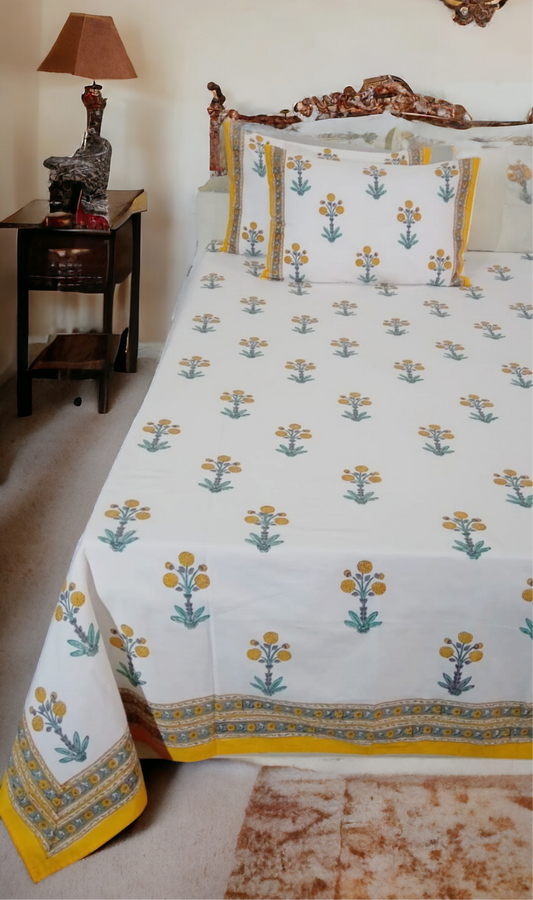 Bed with floral patterned bedspread in a bedroom setting
