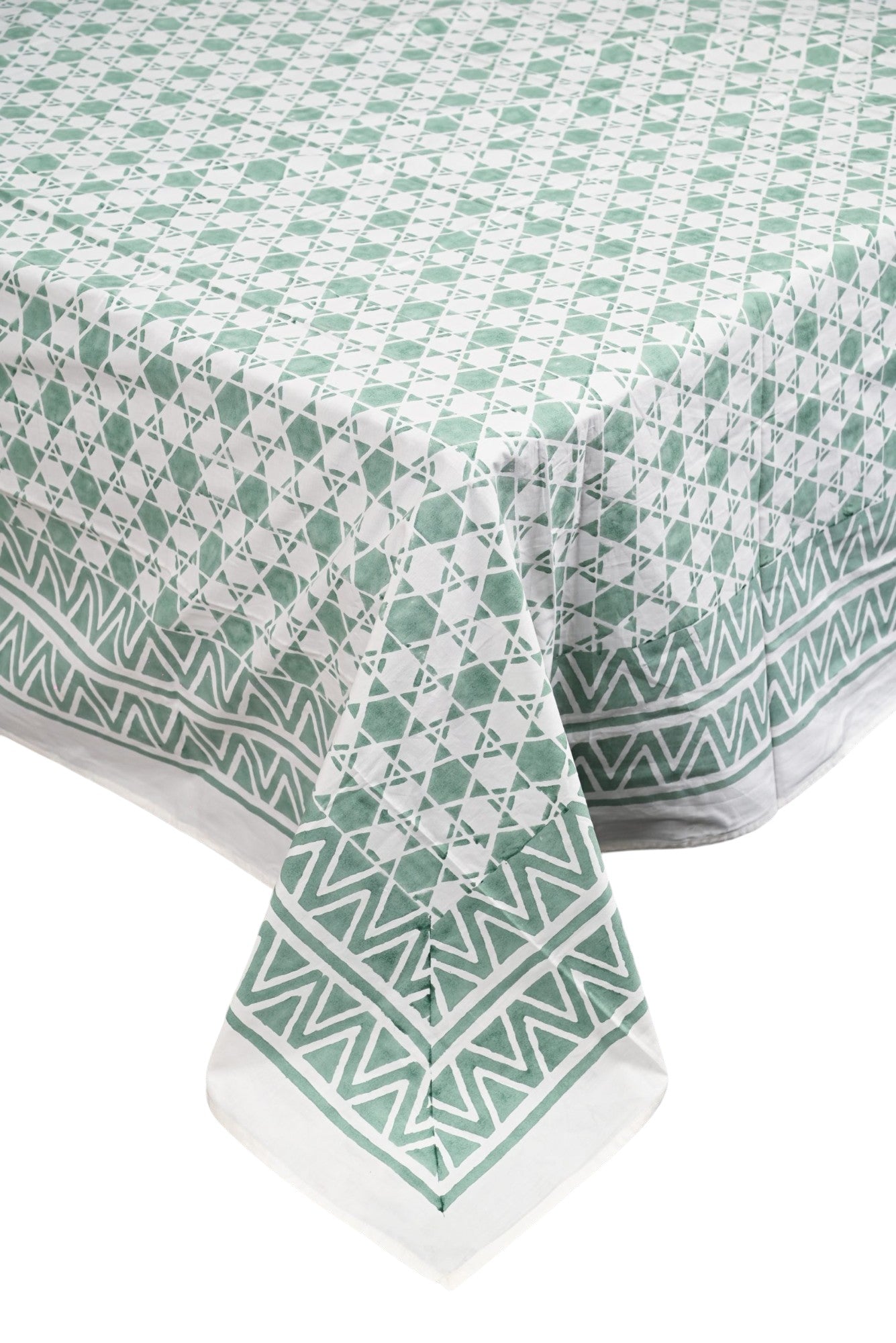 Green and white patterned tablecloth on a white background