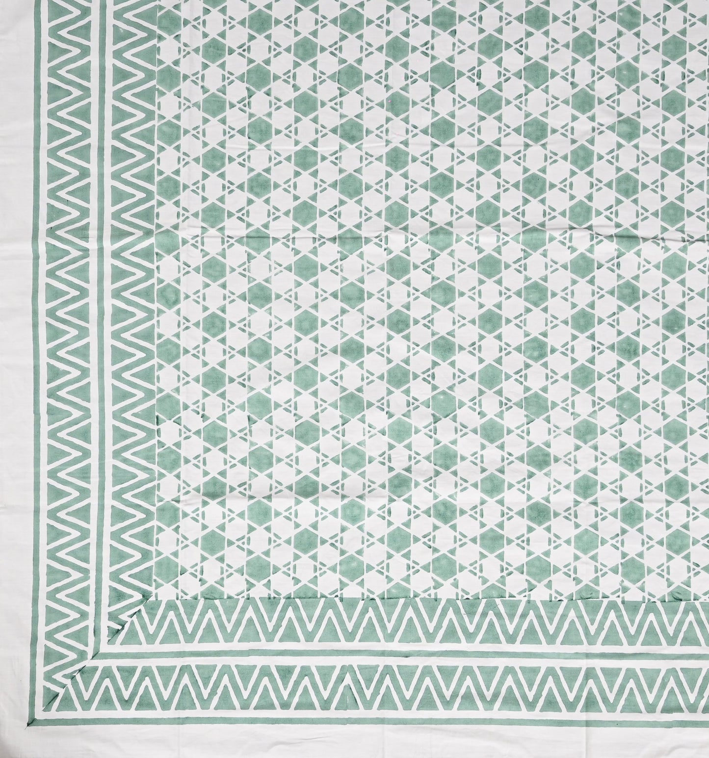 Geometric patterned fabric with green and white colors
