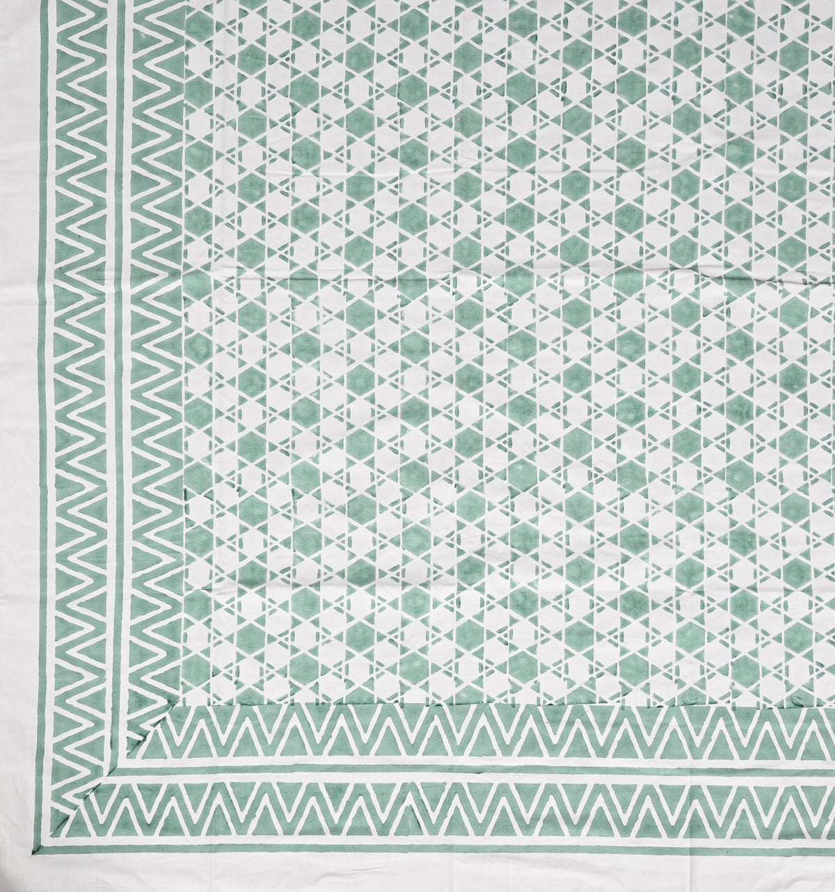 Geometric patterned fabric with green and white colors