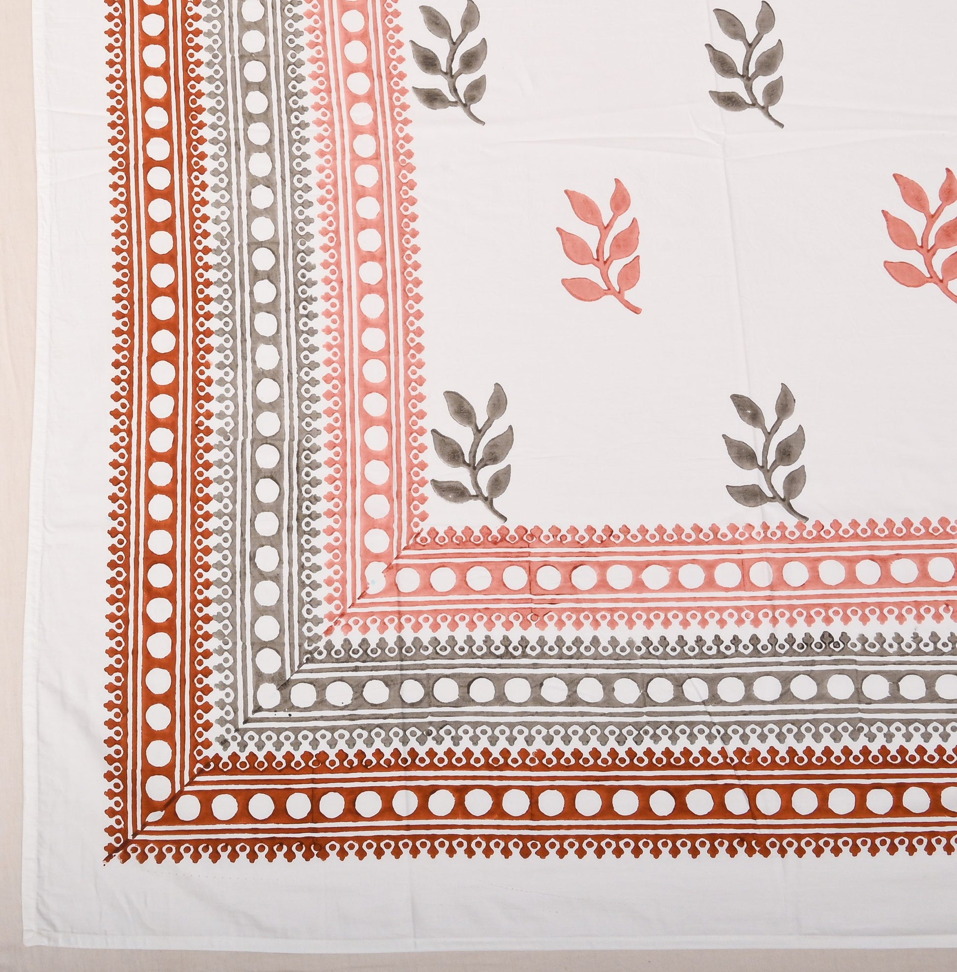 Bedsheet with floral and border patterns on a white background