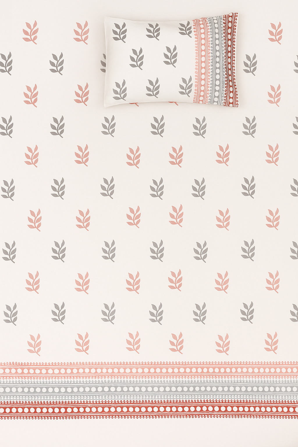 Patterned bedspread with leaf design and striped border on a white background