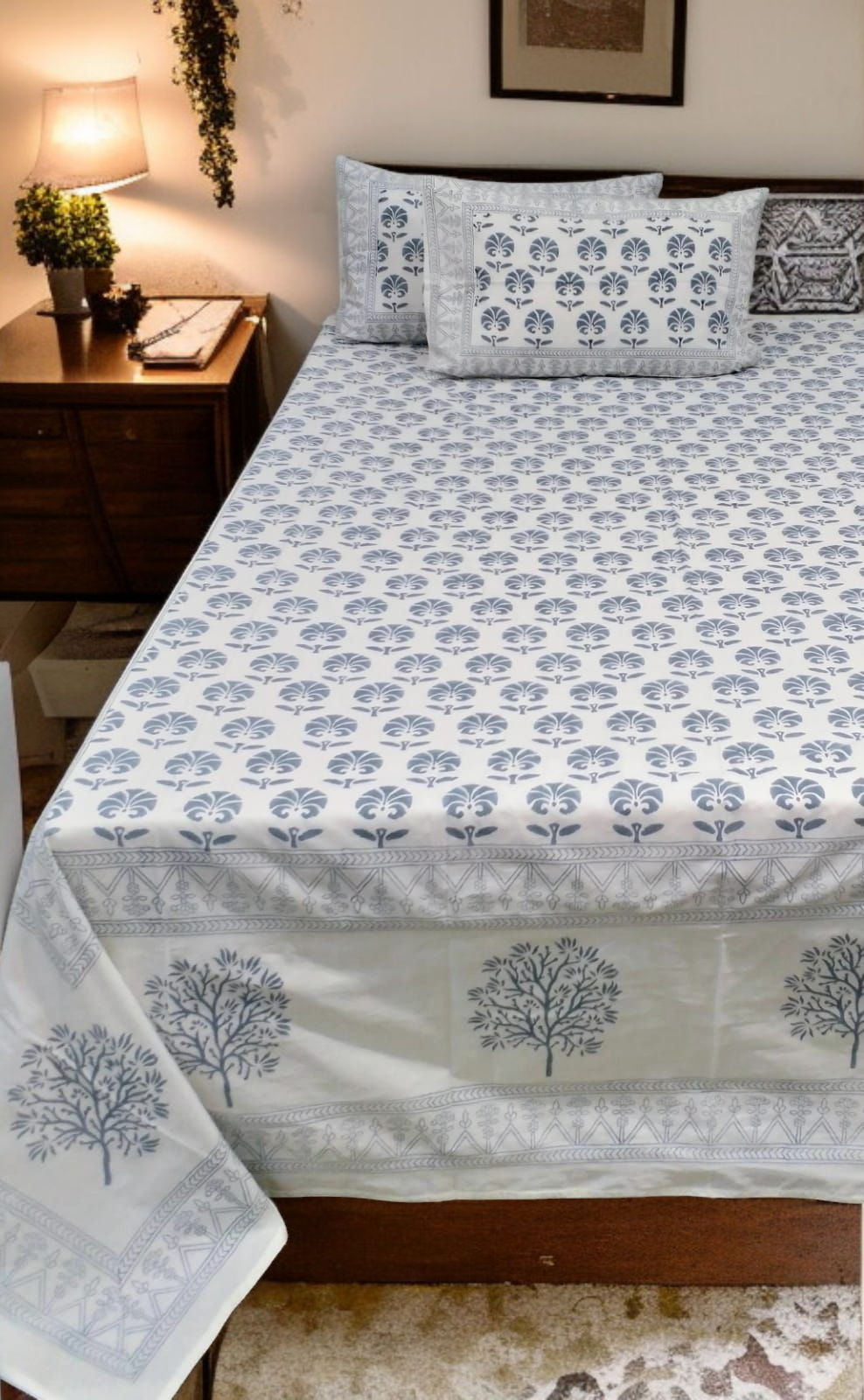 Bed with floral patterned bedspread in a bedroom setting