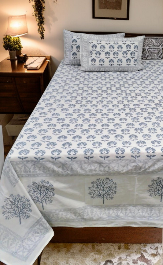 Bed with floral patterned bedspread in a bedroom setting
